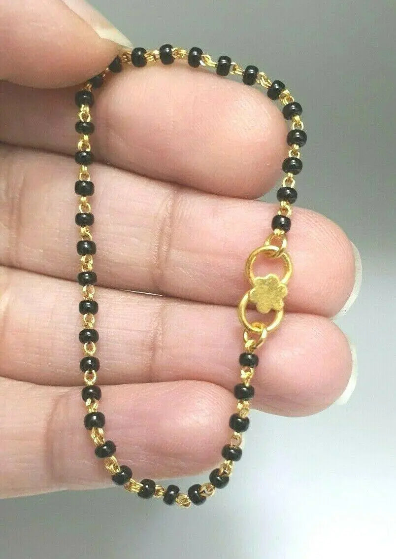 18ct Yellow Gold Baby Bracelet Black Beaded With Diamond Cut Design 